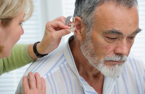 old man with hearing aids